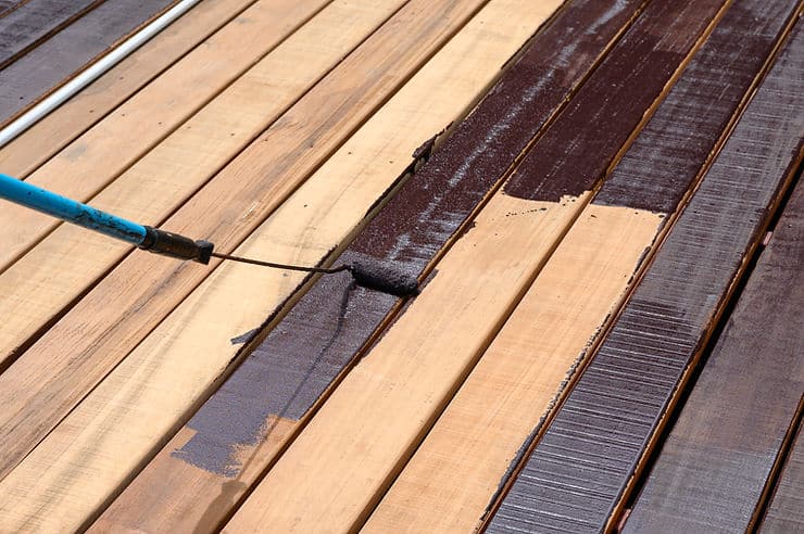 Workers doing staining services on the deck
